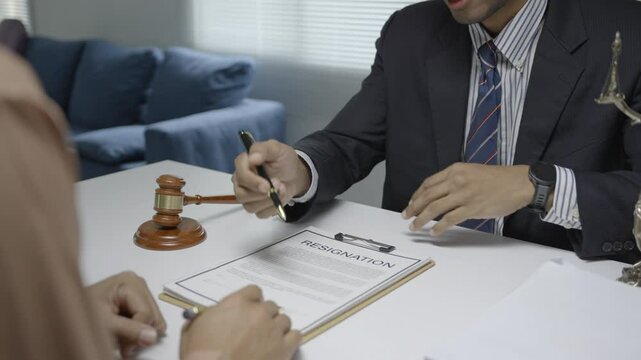 Lawyer explaining resignation terms to client, offering legal advice and support during employment termination process