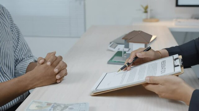 Businessman signing resignation letter and receiving compensation money from Human Resource Manager