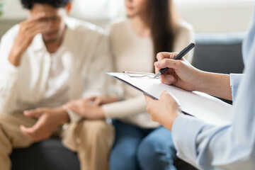 Spouses relationship consultant concept, Close-up hands of psychologist holding pen and note during...