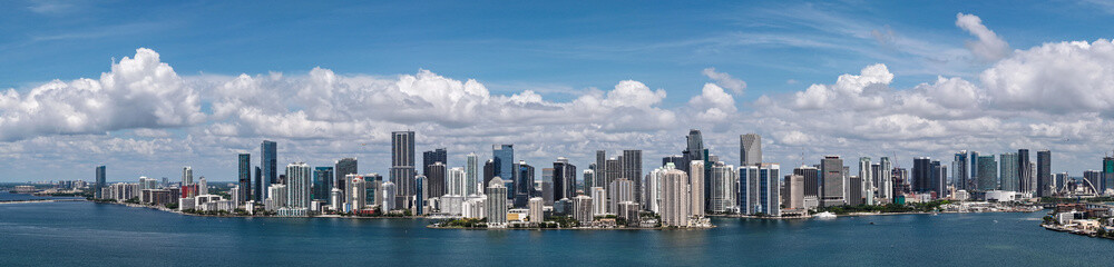 Fototapeta premium Aerial panorama of Brickell in Miami. Downtown Miami skyline on a sunny day. Scenic view of Miami Beach and Brickell. Miamis Skyscrapers. Brickell famous landmarks. Miami downtown landscape.