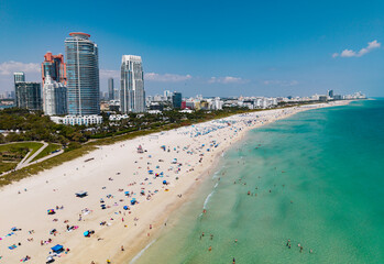 Miami beach with turquoise waters. Aerial view of sandy coastline and waves.