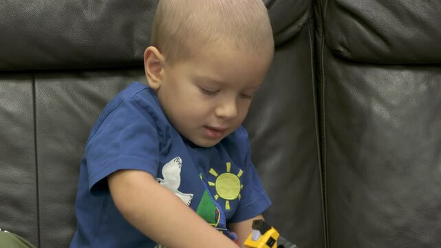 Child unpacking box with robot transformer toy. Face of concentrated little boy taking new toy out of package.