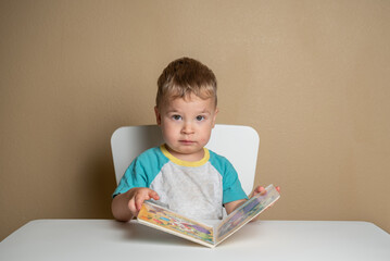 Toddler Concentrates While Looking at Pages