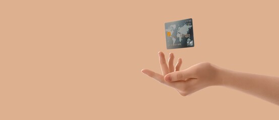 Hand and flying credit card on beige background with space for text