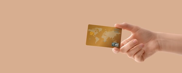 Hand holding credit card on beige background with space for text