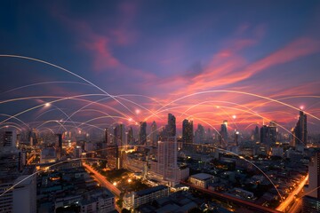A wide shot of the Bangkok cityscape at sunset, with colorful light trails and digital lines connecting buildings across the horizon,