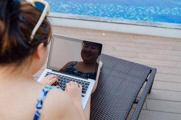 Obese Woman Vacation Traveling Laptop Technology working on laptop in in the swimming pool holiday...