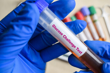 Glucose Challenge - Test with blood sample in blue gloved hands. healthcare or Medical concept