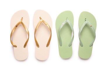 Colorful pairs of female flip flops on white background
