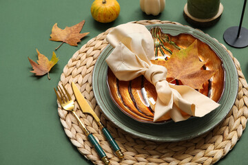 Autumn table setting with leaves on green background