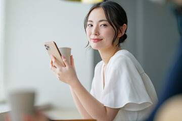 カフェでスマホを使う女性