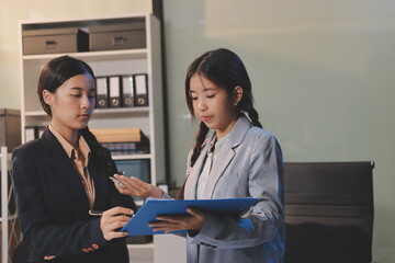  teamwork of tired young business with documents tax laptop computer in office. Sad, unhappy,...