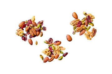 A healthy mix of nuts and dried cranberries scattered on a gray surface isolated on transparent...