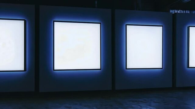 Empty illuminated display panels in a dark gallery