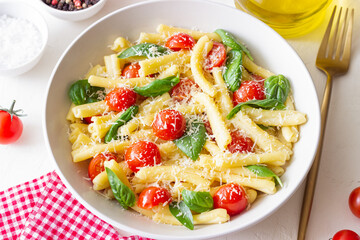 Pasta casarecce with tomatoes, basil and cheese. Italian cuisine. Vegetarian food.