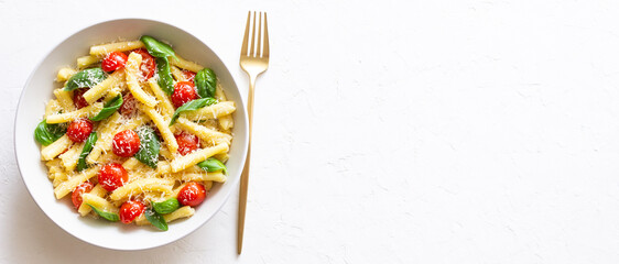 Pasta casarecce with tomatoes, basil and cheese. Italian cuisine. Vegetarian food.