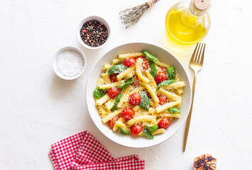 Pasta casarecce with tomatoes, basil and cheese. Italian cuisine. Vegetarian food.