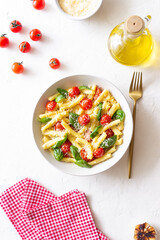Pasta casarecce with tomatoes, basil and cheese. Italian cuisine. Vegetarian food.