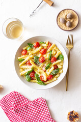 Pasta casarecce with tomatoes, basil and cheese. Italian cuisine. Vegetarian food.
