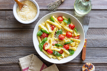 Pasta casarecce with tomatoes, basil and cheese. Italian cuisine. Vegetarian food.