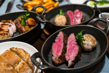 Juicy steak sliced on cast iron plate