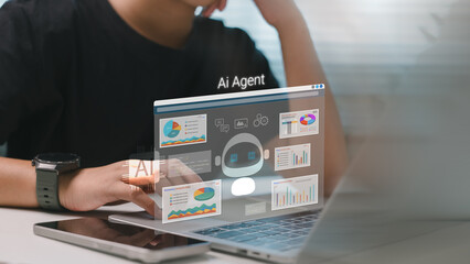 Person analyzing data on laptop with AI agent dashboard hologram, featuring charts, graphs, and coding elements representing artificial intelligence in data-driven decision making.
