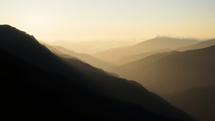 Minimal wide landscape shot of layered mountain silhouettes during sunrise, with mist covering the valleys and soft light breaking through clouds. Calm, peaceful tone, high-resolution matte texture, n