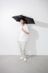 Full body of man with glasses holding parasol