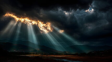 Dramatic Sunbeams Breaking Through Dark Storm Clouds Over Mountain Landscape perfect for environmental campaigns, cinematic backdrops, nature documentaries, spiritual themes weather-related content