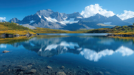 Obraz premium bright blue alpine lake reflecting rocky mountain peaks under clear sky