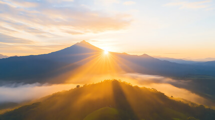 A stunning sunrise over mountains, casting warm golden sunlight across the serene landscape and creating a peaceful atmosphere.