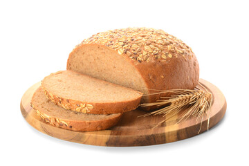 Wooden board with sliced loaf of bread, seeds and wheat spikelets on white background