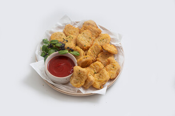 Breaded chicken nuggets with sauce and salad on a plate on a white background