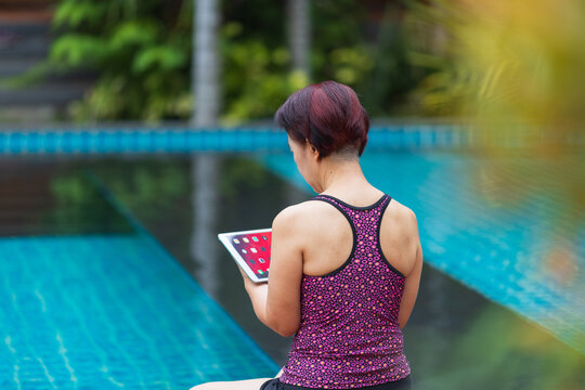 Senior asian woman have relax and recreation on swimming pool.