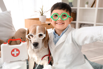 Cute little doctor with Beagle dog taking selfie in bedroom, closeup