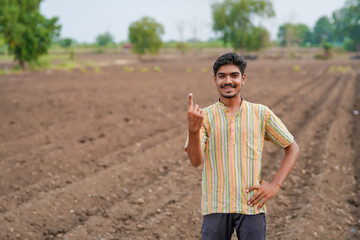 Young Indian farmer showing finger after voting