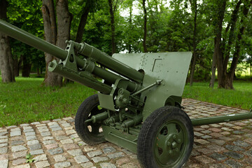 Military green cannon on the fort. Artillery weapon from the Second World War