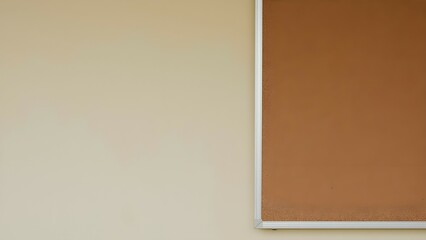 Fototapeta premium A beige classroom wall with a notice board. 