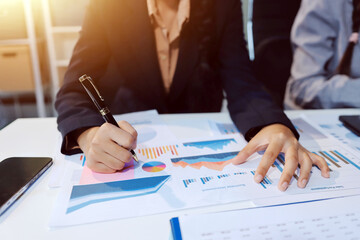 Team of business people working together in the meeting room office, teamwork background charts and...