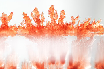 A macro photograph of vividly red, lab-grown crystals, showcasing their intricate geometric...