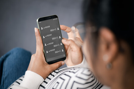 Wireless communications and social concept. Woman with smartphone with instant messaging on the screen. All screen graphics made up. Woman using instant messaging app on mobile phone.
