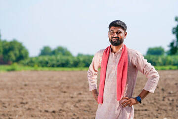indian farmer standing at agricultural field