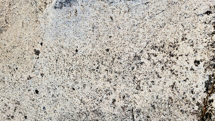 Close-up of a natural mountain rock surface featuring rough and organic textures. Ideal for use in backgrounds, design elements.