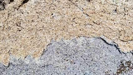 Close-up of a natural mountain rock surface featuring rough and organic textures. Ideal for use in backgrounds, design elements.