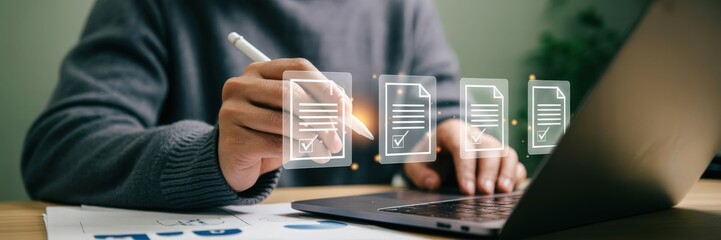 Person reviewing documents on a laptop.