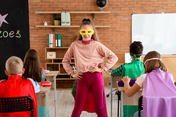 Teenage girl dressed as superhero in classroom