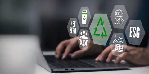 A business person using laptop with esg concept on visual screen.