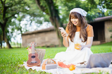 Family enjoys leisure picnic outdoors with people relaxing on blanket surrounded by nature and...
