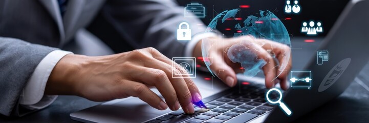Close-up view of hands typing on a laptop keyboard with digital security interface overlay.