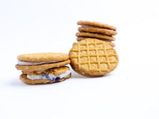 Stack of sandwich cookies with cream and blueberry filling on a white background